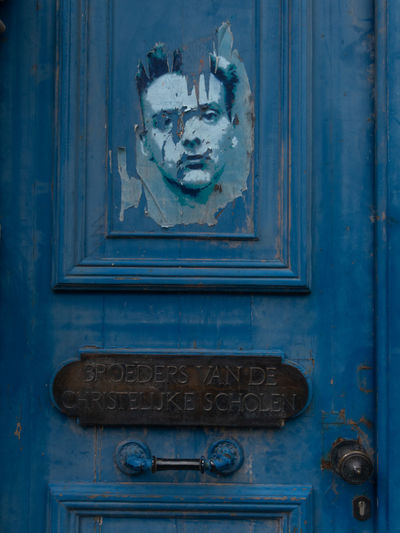 Close-up of mailbox on blue door