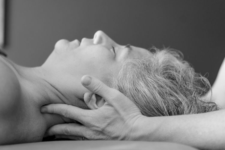 Message therapist massaging woman at spa