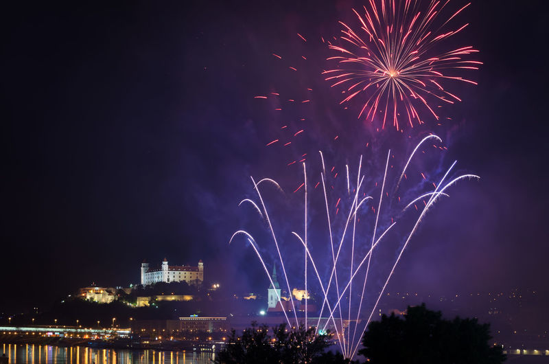 Low angle view of fireworks against sky at night