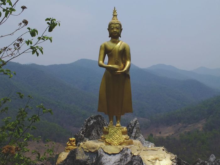 Statue of buddha against mountain
