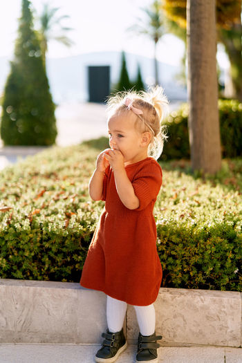 Full length of cute girl standing outdoors