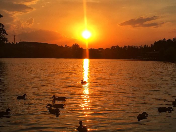 Scenic view of lake against sky during sunset