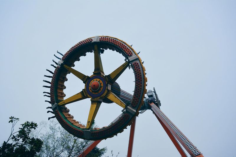 Low angle view of ferris wheel against clear sky