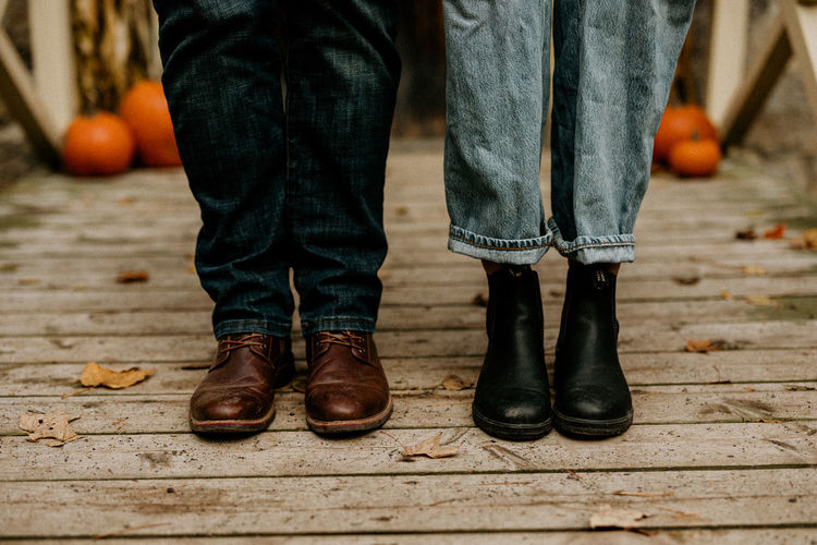 Low section of man and woman standing on a deck