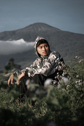 Portrait of beautiful young woman on land