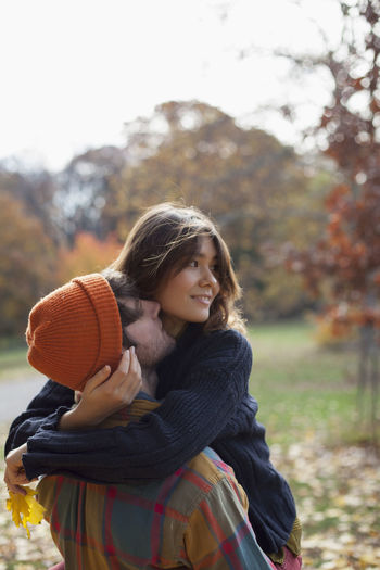 Happy young couple embracing in a park