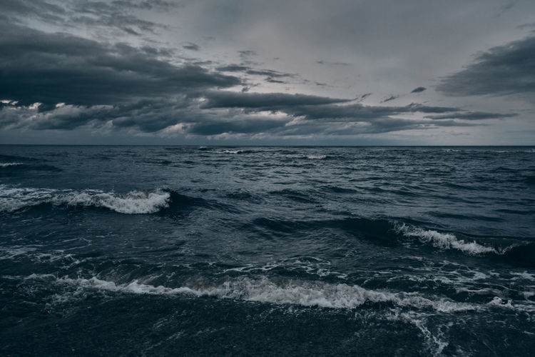Dramatic view of an empty sea with heavy clouds and rough waves.