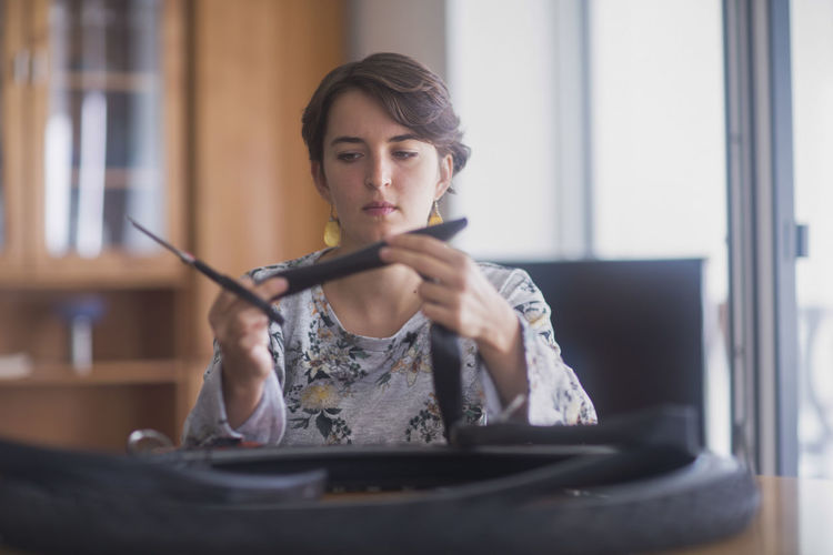 Upcycling young woman at home