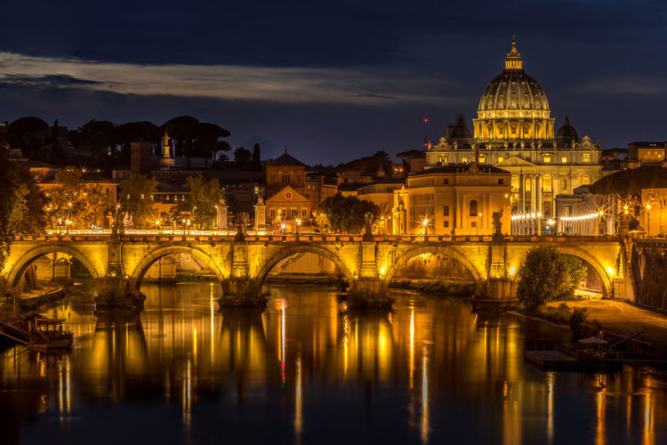 Ponte sant angelo over tiber river in city at night