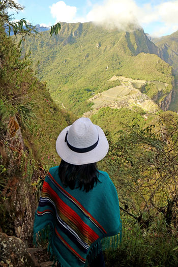 Rear view of woman wearing hat looking at mountain