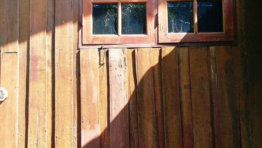 Full frame shot of window on wooden wall