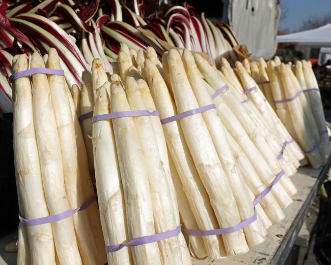 Large bunch of white asparagus for sale at the greengrocer