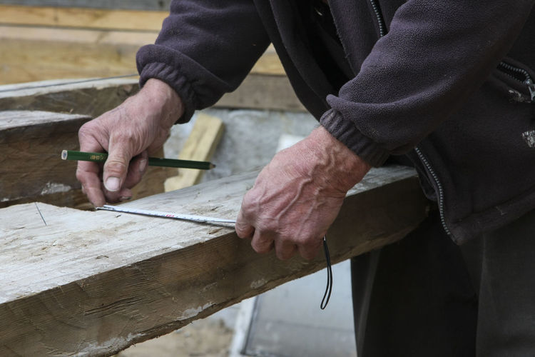 Close-up of man working on wood