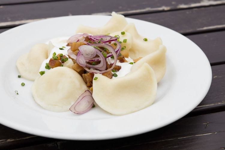 Pierogi with bacon and cream in plate