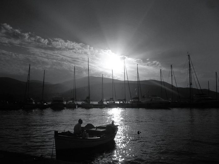 Boats in sea during sunset