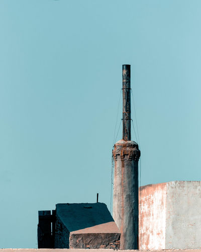 Low angle view of a chimney against sky
