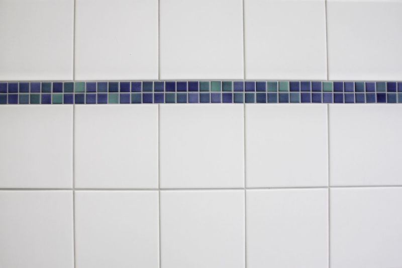 Close-up of white tiled wall