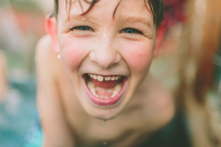 Close-up portrait of smiling shirtless boy