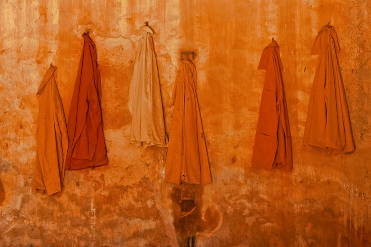 Clothes drying on wood against wall