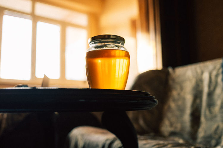 A jar of honey on the table at home. high quality photo
