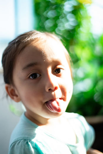 Portrait of girl sticking out tongue