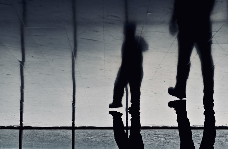 Silhouette people walking on floor