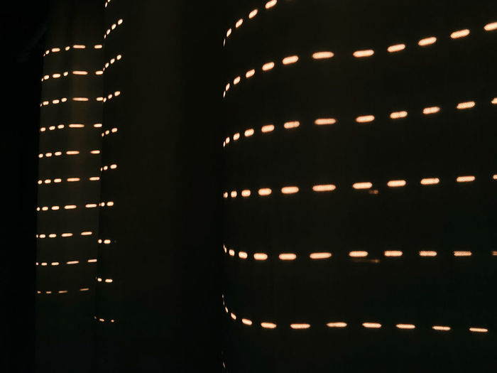 Full frame shot of illuminated light bulbs in building