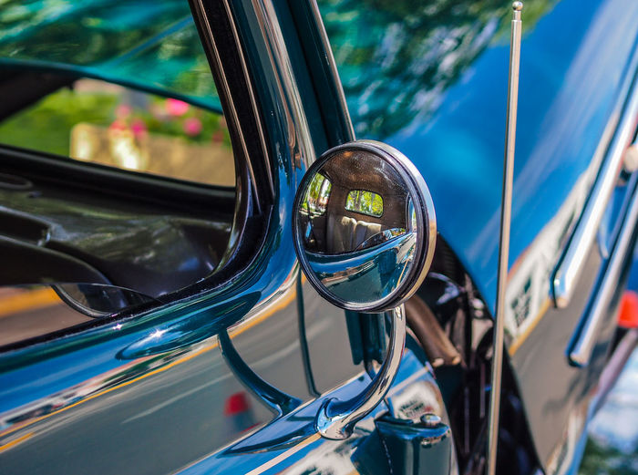 Close-up of side-view mirror on vintage car