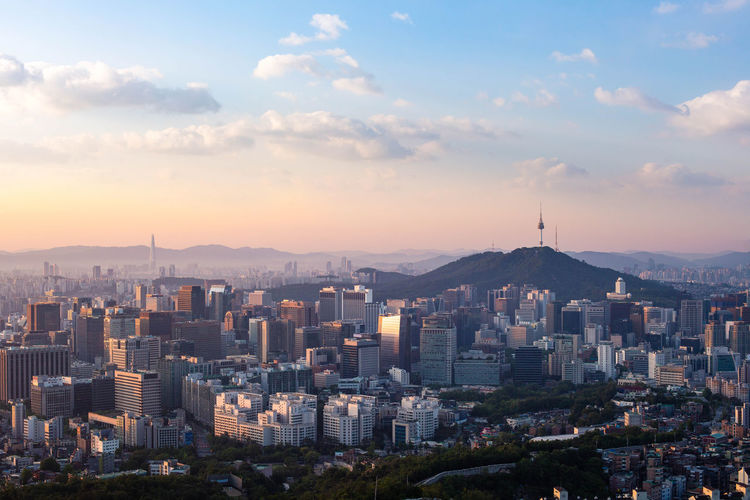 High angle view of buildings in city against sky during sunset