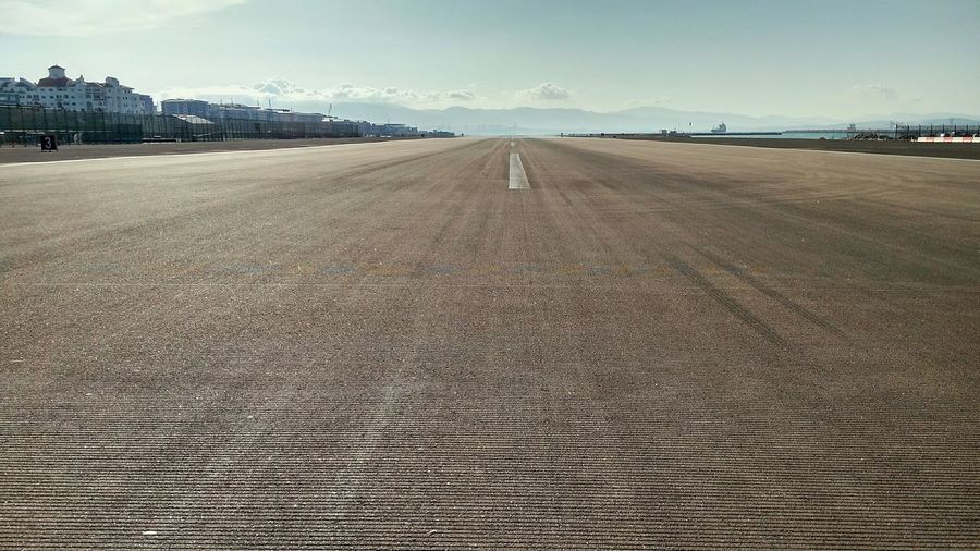 Scenic view of airport runway against sky