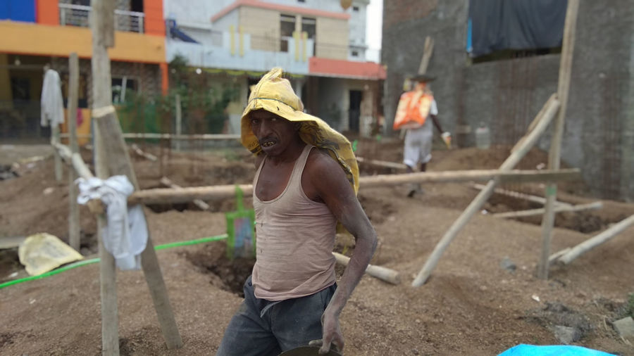 Rear view of men working at construction site