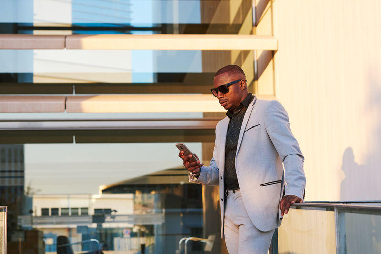 African american businessman with mobile phone on a summer afternoon.