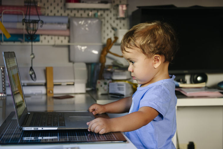 Young child watching videos on a laptop