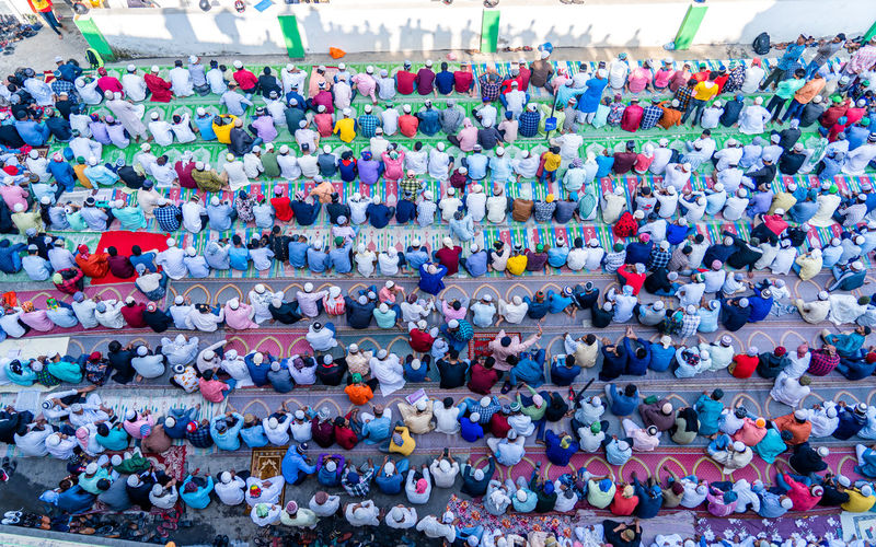 High angle view of crowd praying on road