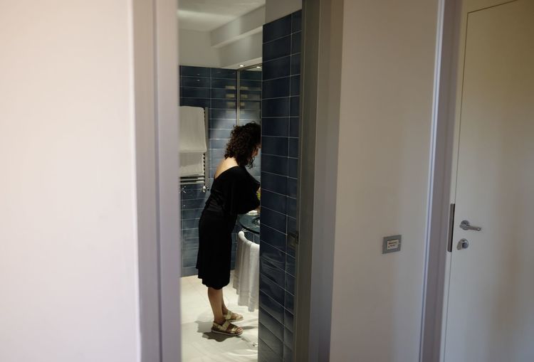 Side view of woman standing in bathroom