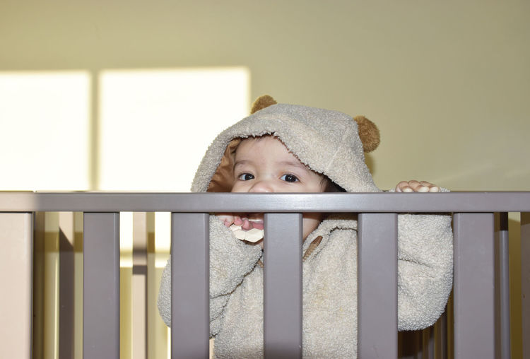 Portrait of baby boy in crib