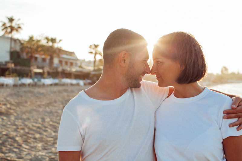 Happy portrait couple in love on the beach. diverse couple on summer vacation.