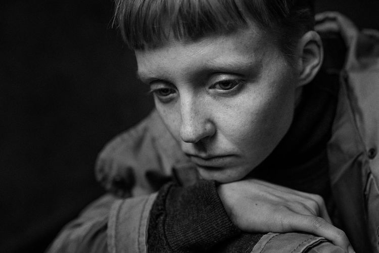 Close-up of depressed woman in darkroom