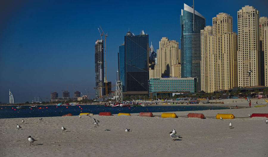 View of beach against buildings in city