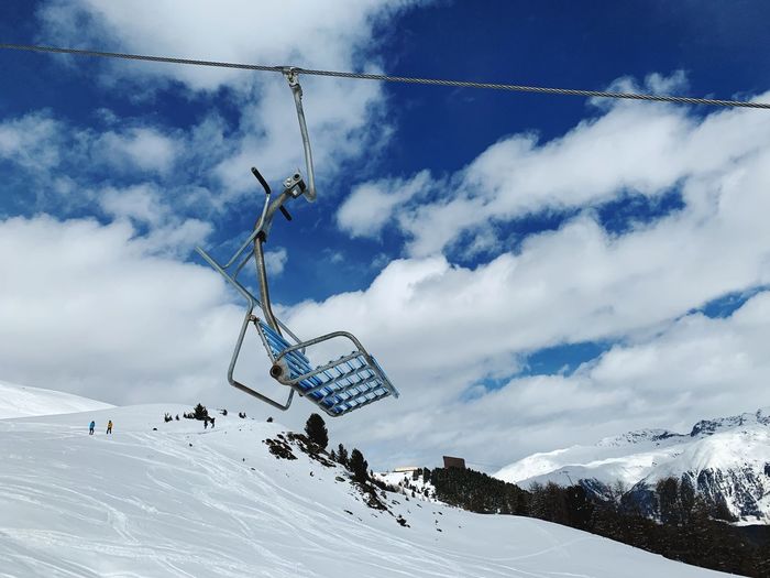 Overhead cable car against snowcapped mountains during winter
