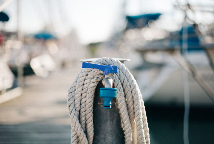 Close-up of rope tied to harbor