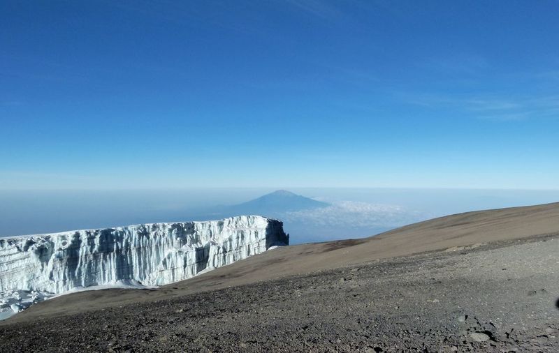 Glacier on mount kilimanjaro with mount meru in the background 