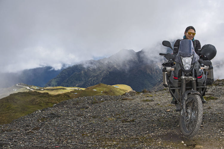 Woman on touring motorbike at the pass of abra de malaga (4316 m)