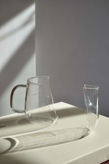Close-up of broken drinking glass on table