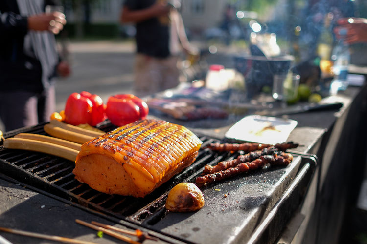Fresh food grilling on barbecue against road
