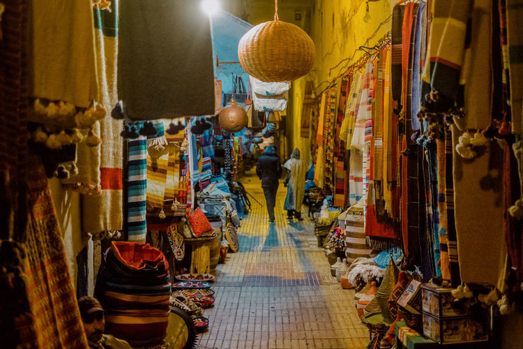 Illuminated lanterns hanging at market stall