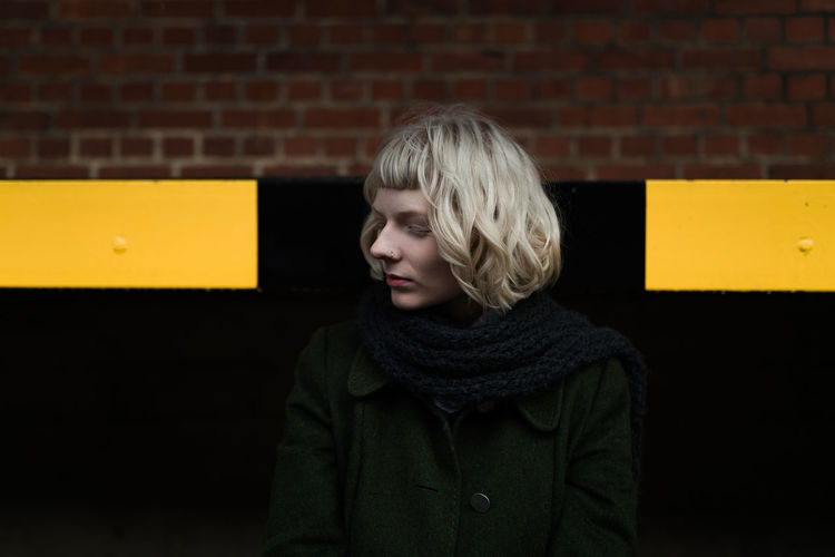 Adult Adults Only Blond Hair Brick Wall Day Hamburg Headshot One Person One Woman Only One Young Woman Only Only Women Outdoors People Student Warm Clothing Watching Women Young Adult Young Women Paint The Town Yellow