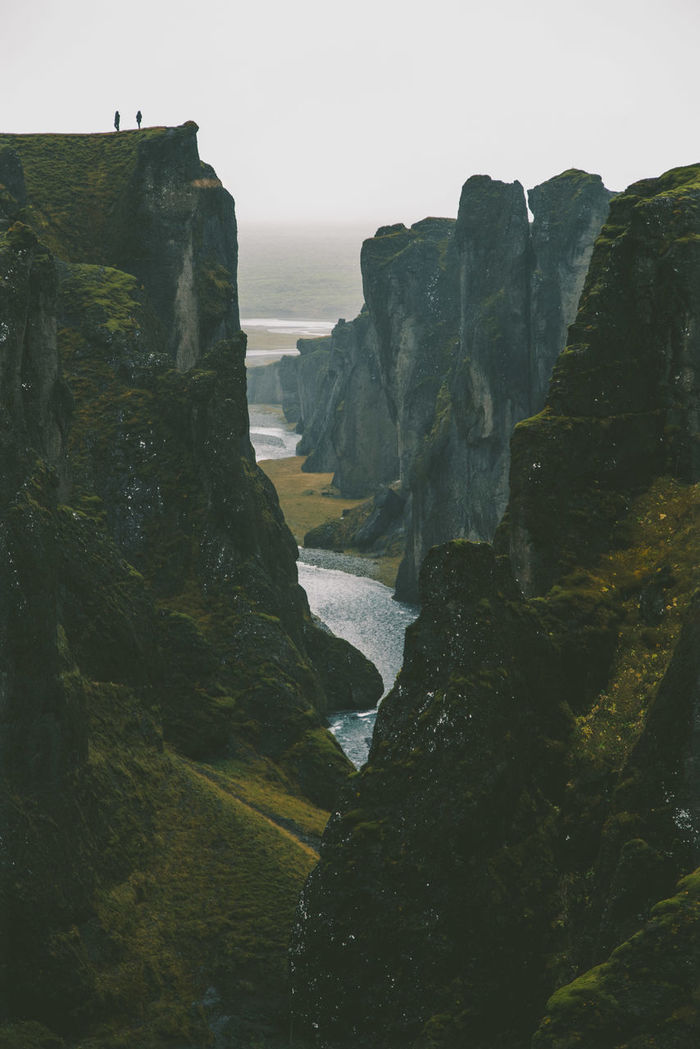 Scenic view of river among cliffs
