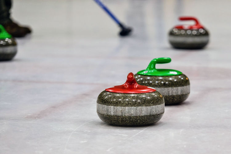 Close-up of curling stones on ice rink