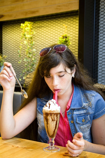 Young woman having dessert at cafe
